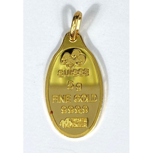 722 - A yellow metal oval pendant stamped 'Suisse 5g 999.9', the loop stamped 750