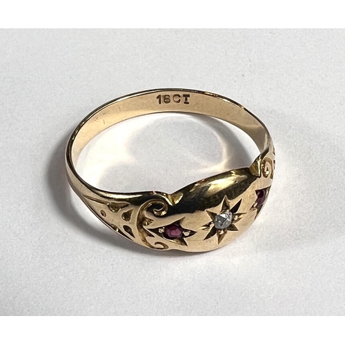 727A - A lady's gold dress ring with central diamond in star cut surround flanked by 2 small rubies, shank ... 