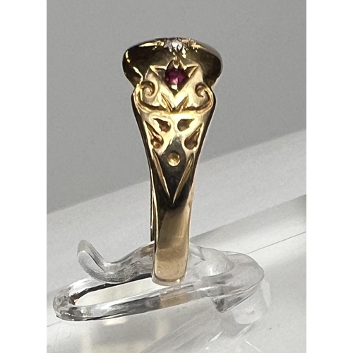 727A - A lady's gold dress ring with central diamond in star cut surround flanked by 2 small rubies, shank ... 