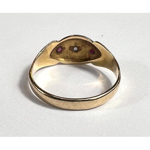 727A - A lady's gold dress ring with central diamond in star cut surround flanked by 2 small rubies, shank ... 