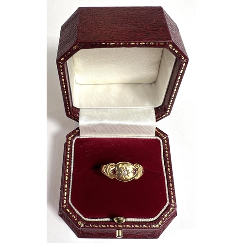 727A - A lady's gold dress ring with central diamond in star cut surround flanked by 2 small rubies, shank ... 