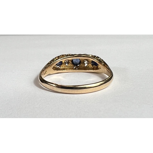 728A - An 18ct hallmarked gold 'gypsy' style dress ring set with 3 sapphires and 2 small diamonds, 3.2gm, s... 