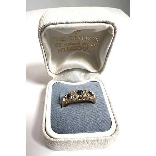 728A - An 18ct hallmarked gold 'gypsy' style dress ring set with 3 sapphires and 2 small diamonds, 3.2gm, s... 