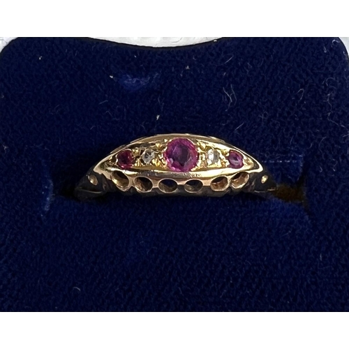 729 - An 18ct hallmarked gold 'gypsy' style lady's dress ring set with 3 rubies and 2 small diamonds, 1.8g... 