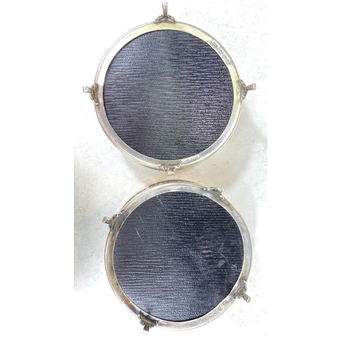 731 - A pair of secessionist style hallmarked silver coasters with wooden bases, Birmingham 1919