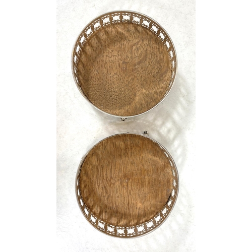 731 - A pair of secessionist style hallmarked silver coasters with wooden bases, Birmingham 1919