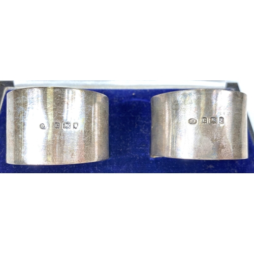 732A - A pair of hallmarked silver napkin rings, boxed, another, boxed, 46.6gm (15oz); a hallmarked silver ... 