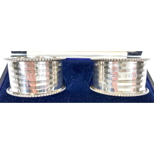 736 - A hallmarked silver pair of napkin rings, Birmingham 1915; a hallmarked silver pair of circular... 