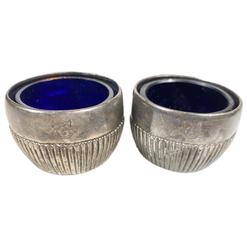 736 - A hallmarked silver pair of napkin rings, Birmingham 1915; a hallmarked silver pair of circular... 