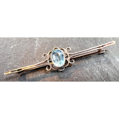 758 - A 9 carat gold bar brooch set with aquamarine colour oval stone, boxed.