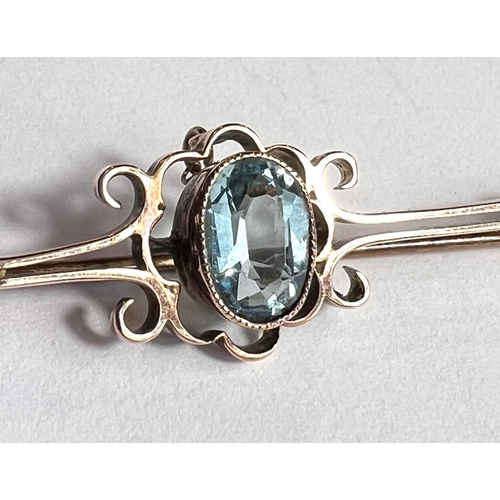 758 - A 9 carat gold bar brooch set with aquamarine colour oval stone, boxed.