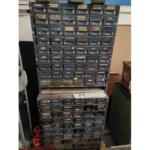 102 - A large two height unit of industrial drawers with a large quantity of small drawers for collecting ... 