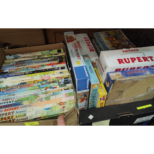 357 - A collection of vintage Rupert Bear jigsaws, vintage annuals, videos and cassette tapes