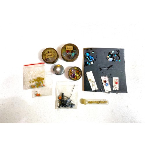 614 - A selection of loose opals and semi precious stones (the opals applied to card with vegetable glue)