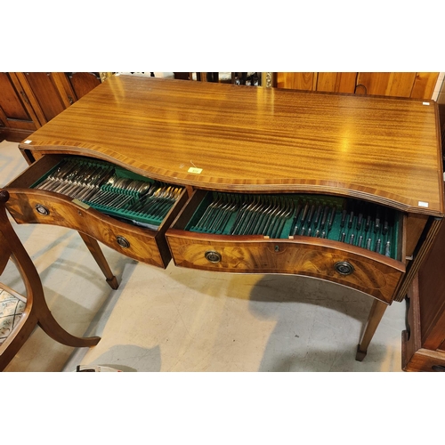 872 - A Regency style mahogany side table with crossbanded decoration, serpentine front, 2 drawers and dro... 