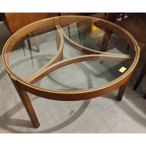 935 - A 1970's nest of 4 teak occasional tables, 1 with circular glass top, the others with oval tops