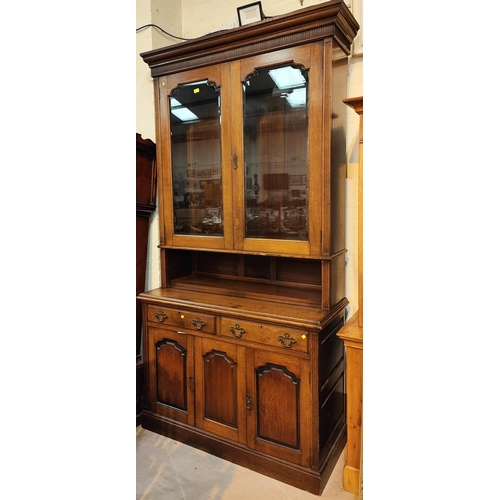 939 - A 19th century oak full height side cabinet in the Georgian style, the upper section enclosed by twi... 