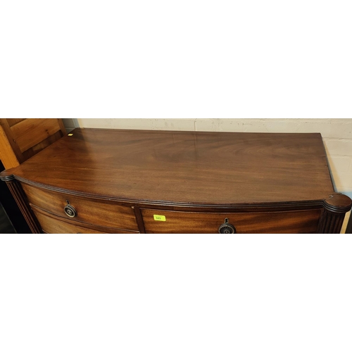 945 - A Regency period mahogany chest of 7 drawers with bow front and outset reeded side columns, on turne... 