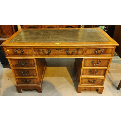 952 - A reproduction yew wood desk, twin pedestals with 3 frieze and 6 pedestal drawers