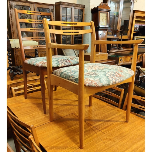 968 - A 1970's G Plan style teak dining suite, comprising of a rectangular extendable table and 6 pierced ... 