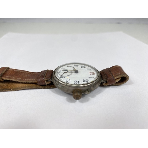 731A - A large silver cased officers trench watch with screw in movement, seconds dial, leather strap 