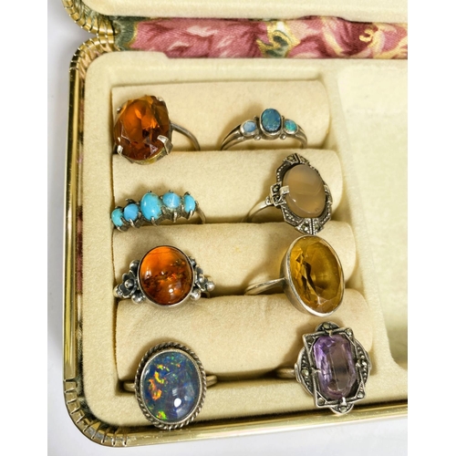 770 - 8 decorative white metal and coloured stone rings.