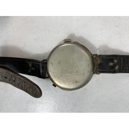 779E - A WWI period officers trench watch with spring protective monogrammed front, on leather strap