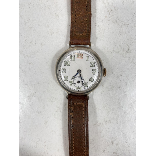 779F - A silver cased officers style trench watch on leather strap