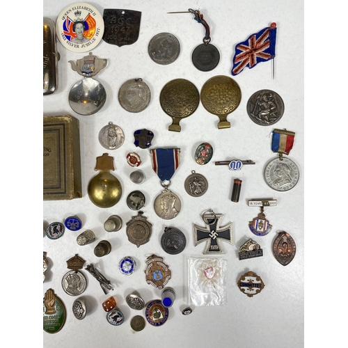 751B - A selection of small collectables including medallions, thimbles, tea caddy scoops, badges etc.