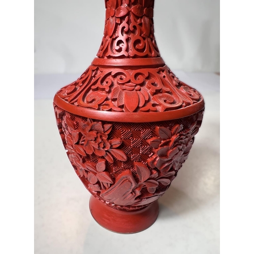 521A - A Chinese boxed cinnabar coloured vase, height 20cm.