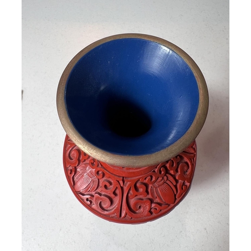 521A - A Chinese boxed cinnabar coloured vase, height 20cm.