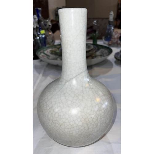 524L - A Chinese crackle glaze bottle shaped vase in white, ht. 27cm, seal mark to base