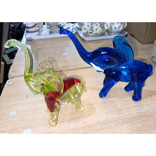 587 - A blue Murano glass elephant and a similar yellow and red glass Murano elephant, both with raised tr... 