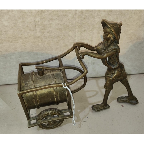 75A - A Benin bronze figure of man pushing barrel on wheels, (from a private collection)