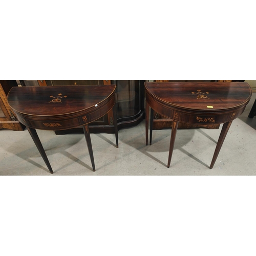 925 - A pair of Sheraton period rosewood card tables, the fold-over demilune tops with boxwood line and fl... 