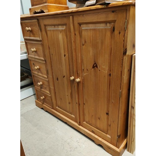 932 - A modern pine side cabinet with double cupboard and 4 drawers