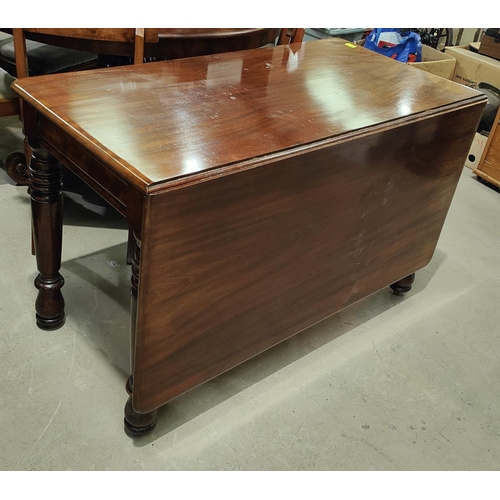 965 - A rectangular mahogany dining table on turned legs.