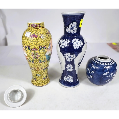 501 - A Chines yellow ground baluster shaped covered vase decorated with jenne? panels, 28cm; a blue and w... 