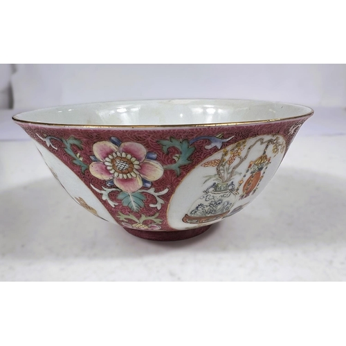 508 - A Chinese bowl with pink ground, circular panels of vases and objects, seal mark to base, diameter 1... 