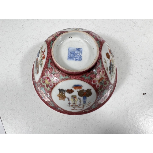 508 - A Chinese bowl with pink ground, circular panels of vases and objects, seal mark to base, diameter 1... 