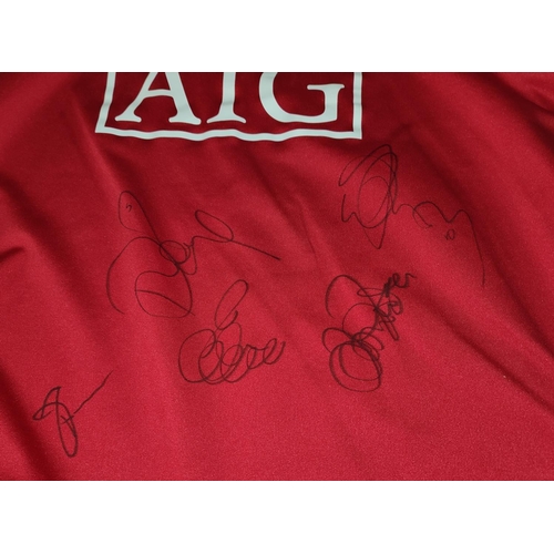 113A - A Manchester United shirt, bearing signatures, other United items and a selection of prints and a ch... 