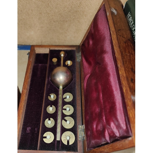 126 - A cased hydrometer set; a set of scientific balances and weights.