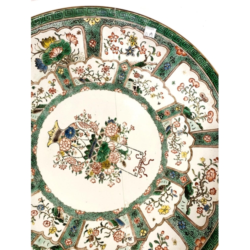 524A - A large Chinese famille vert charger 45cm floral polychrome panels, central panel with flowers, area... 