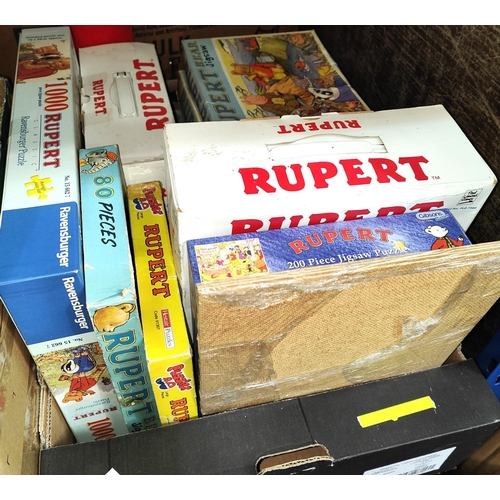 357 - A collection of vintage Rupert Bear jigsaws, vintage annuals, videos and cassette tapes