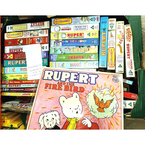 357 - A collection of vintage Rupert Bear jigsaws, vintage annuals, videos and cassette tapes