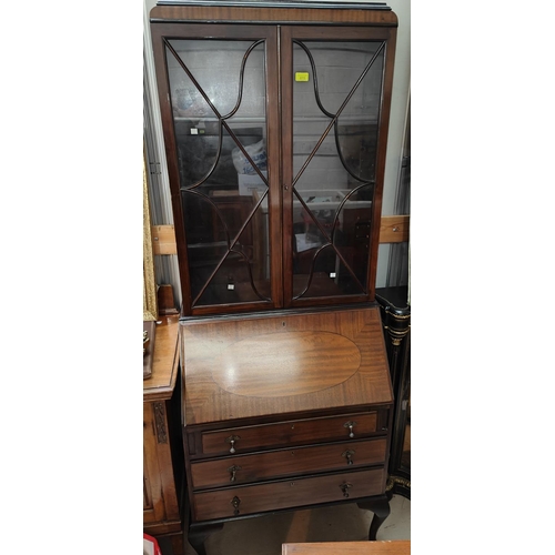 875 - A 1920's mahogany bookcase with 2 glazed doors over fall front, 3 drawers and cabriole legs