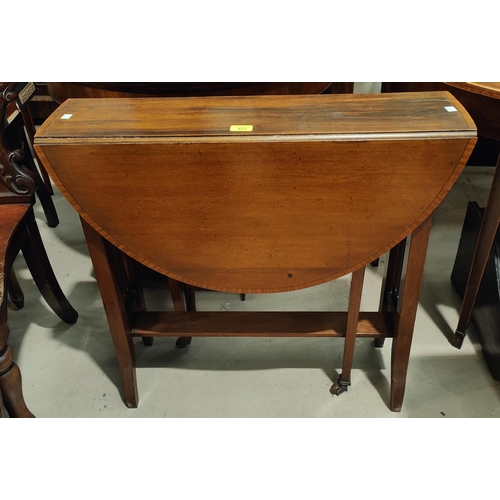 877 - An Edwardian oval walnut Sutherland table on square splay legs