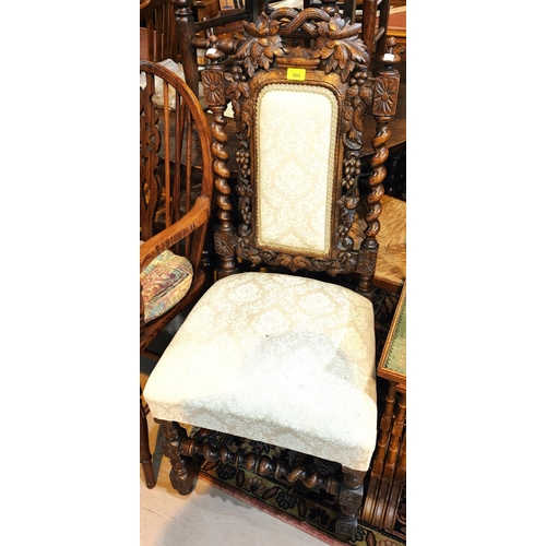 900 - A carved oak hall chair with barley twist supports with grape and vine decoration, and three balloon... 