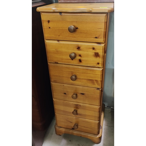 920 - A modern pine tall thin chest of six drawers 