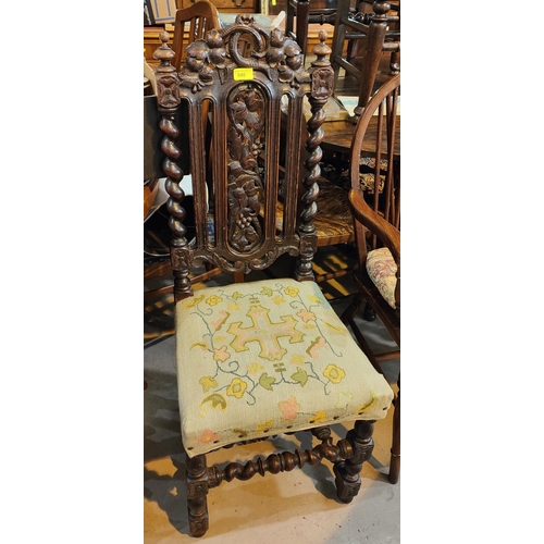 946 - A Carolean style dining chair in carved oak with barley twist columns; a balloon back chair